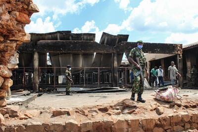 Security officers outside the ruins of the central prison in Gitega. AFP