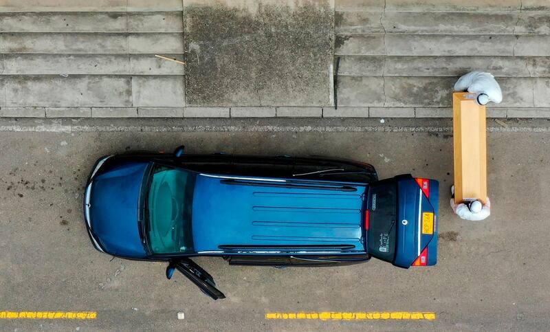 Funeral parlour workers transporting the coffin of a Covid-19 victim to be cremated at Serafin cemetery in Bogota. AFP