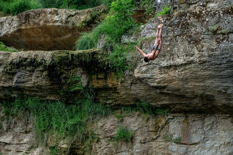 Vedat Krasniqi performs a winning dive from a 17 meter waterfall during a high-diving competition from Mirusha waterfalls in Kosovo, on Sunday, July 12. AP