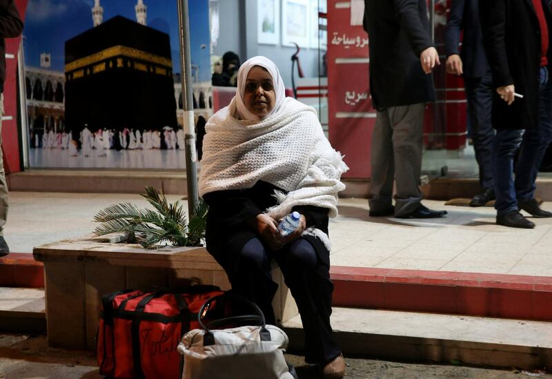 A Palestinian Muslim pilgrim waits for a bus en route to Rafah border between Gaza Strip and Egypt before leaving for the hajj pilgrimage to the holy city of Mecca, in Gaza City.  AP