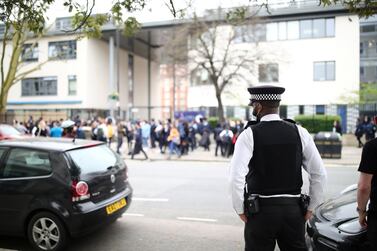 A police officer outside Pimlico Academy, London, where students staged a walkout in protest over a school uniform policy they claim is discriminatory. Aaron Chown/PA Images via Getty Images