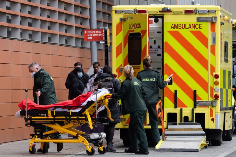 An ambulance crew take a patient to the Royal London Hospital, east London. UK Hospital admissions have been rising due to a surge in Covid-19 infections. EPA
