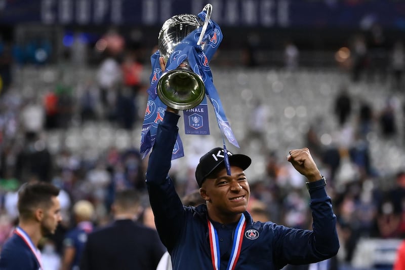 Kylian Mbappe celebrates with the trophy. AFP