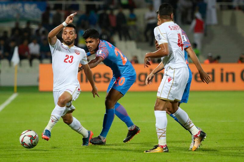 Bahrain's Jamal Rashed, left,  fights for the ball with India's Pritam Kotal. AFP