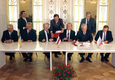 Russia's President Boris Yeltsin, second right, Ukraine's President Leonid Kravchuk, second left, Belarus's leader Stanislav Shushkevich, third left, sign an agreement terminating the Soviet Union. AP Photo