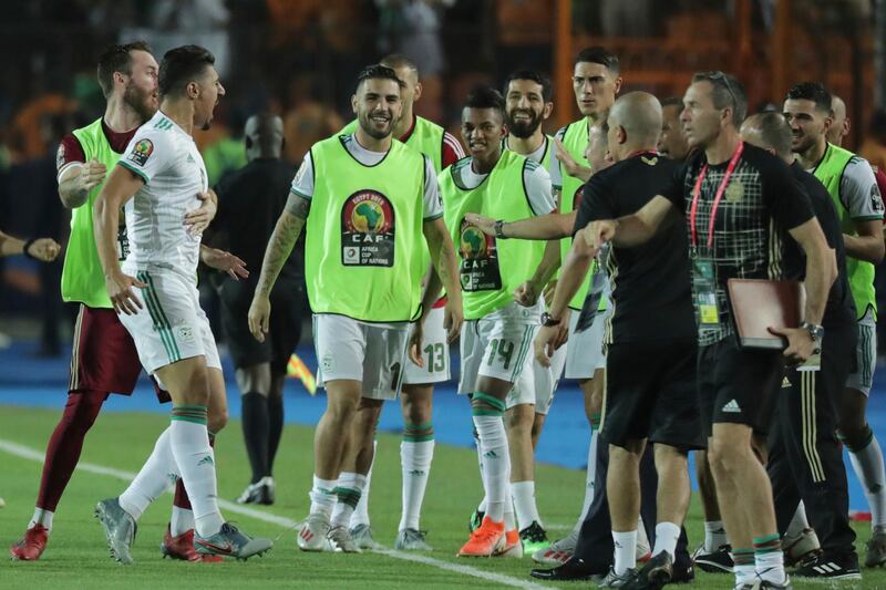 Algeria's Baghdad Bounedjah, left, celebrates with his teammates after scoring the opening goal. AP