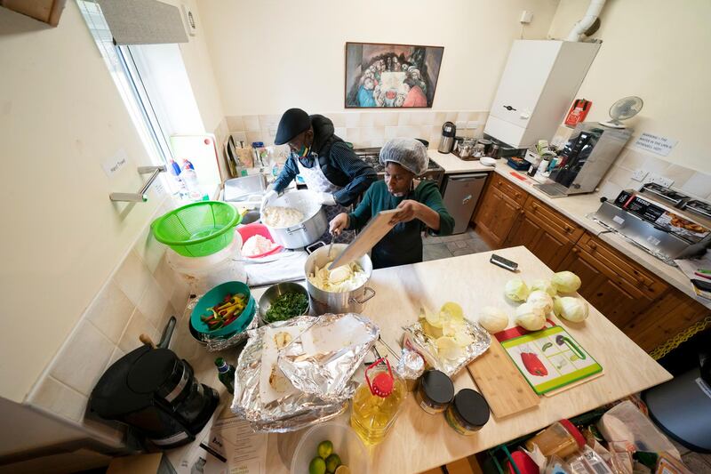 Glenda Andrew and volunteer Dave Williams work in the kitchen. The meal program grew out of Andrew’s work with Preston Windrush Generation and Descendants, a group organized to fight for the rights of early immigrants from the Caribbean and other former British colonies who found themselves threatened with deportation in recent years. AP Photo