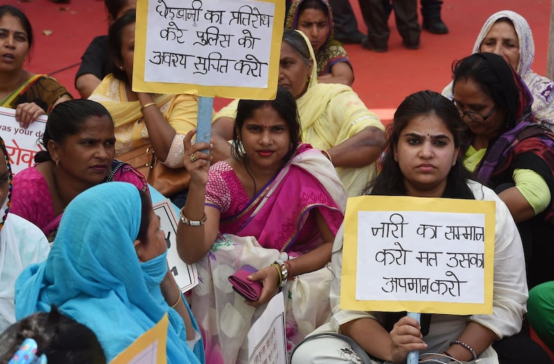 Indian women hold placards during a protest organised by Delhi Commission for Women in New Delhi, India, on April 13, 2018. Money Sharma / AFP