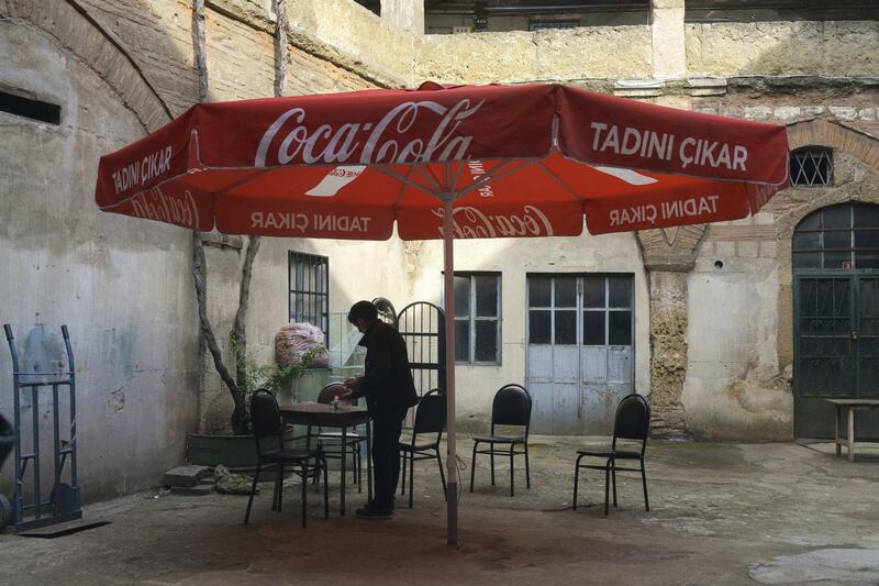 Ozturk cleaning his shop. 18th century building.“Corlulu Ali Pasha” inn-yard in the Küçükpazar district in Istanbul.

The courtyard is entered by passing through the arched door and passage on the street of Kucukpazar, Istanbul. Mehmet, 49, has a family owned tea shop here for 58 years. Istanbul, Turkey 2021