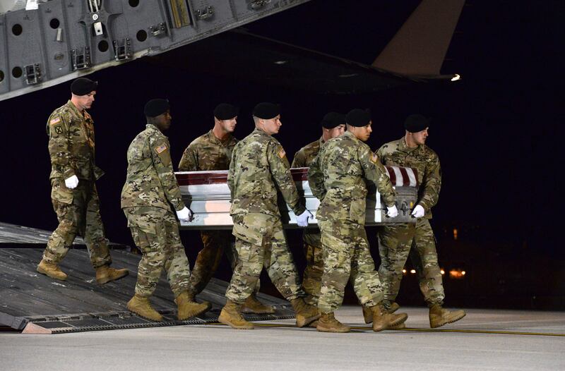 In this image provided by the U.S. Air Force, a U.S. Army carry team transfers the remains of Army Staff Sgt. Dustin Wright of Lyons, Ga., late Thursday, Oct. 5, 2017, upon arrival at Dover Air Force Base, Del.  Wright, 29, of Lyons, Ga., was one of four U.S. troops and four Niger forces killed in an ambush by dozens of Islamic extremists on a joint patrol of American and Niger Force. (Staff Sgt. Aaron J. Jenne/U.S. Air Force via AP)
