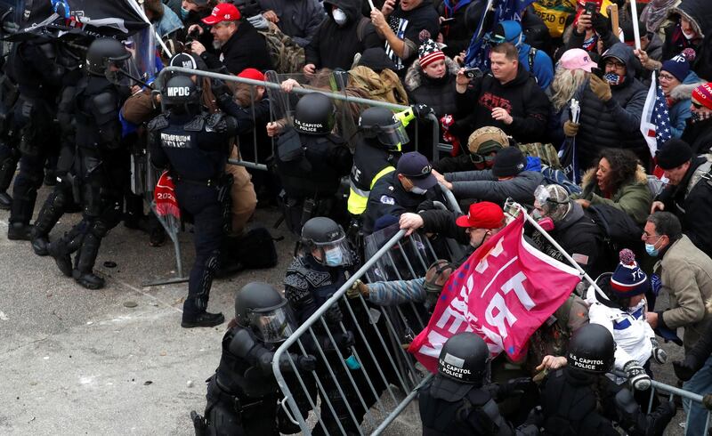 Pro-Trump protesters attempt to tear down a police barricade during a rally to contest the certification of the 2020 U.S. presidential election results by the U.S. Congress, at the U.S. Capitol Building. Reuters