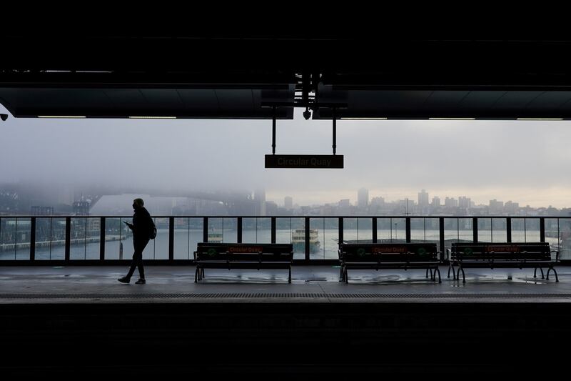 A lone passenger waits for a train at Circular Quay in Sydney, Australia, after a lockdown was imposed to curb the spread of Covid-19.