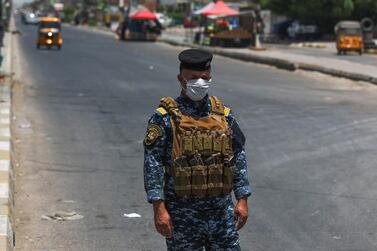 A member of the Iraqi security forces stands guard at a checkpoint, enforcing a curfew due to the COVID-19 coronavirus pandemic, in Baghdad's eastern Sadr City suburb on May 31, 2020. AFP