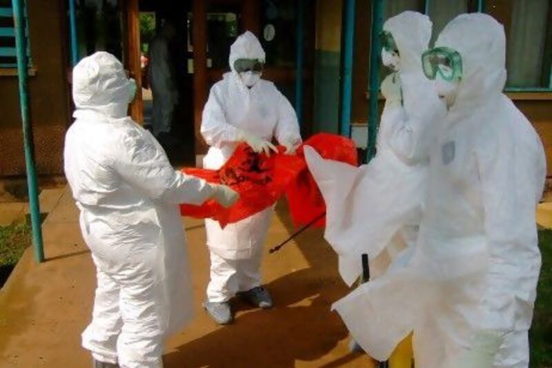 World Health Organization staff wear protective clothing as they prepare to enter Kagadi Hospital, about 200 kilometres from Kampala, where an outbreak of Ebola virus started.