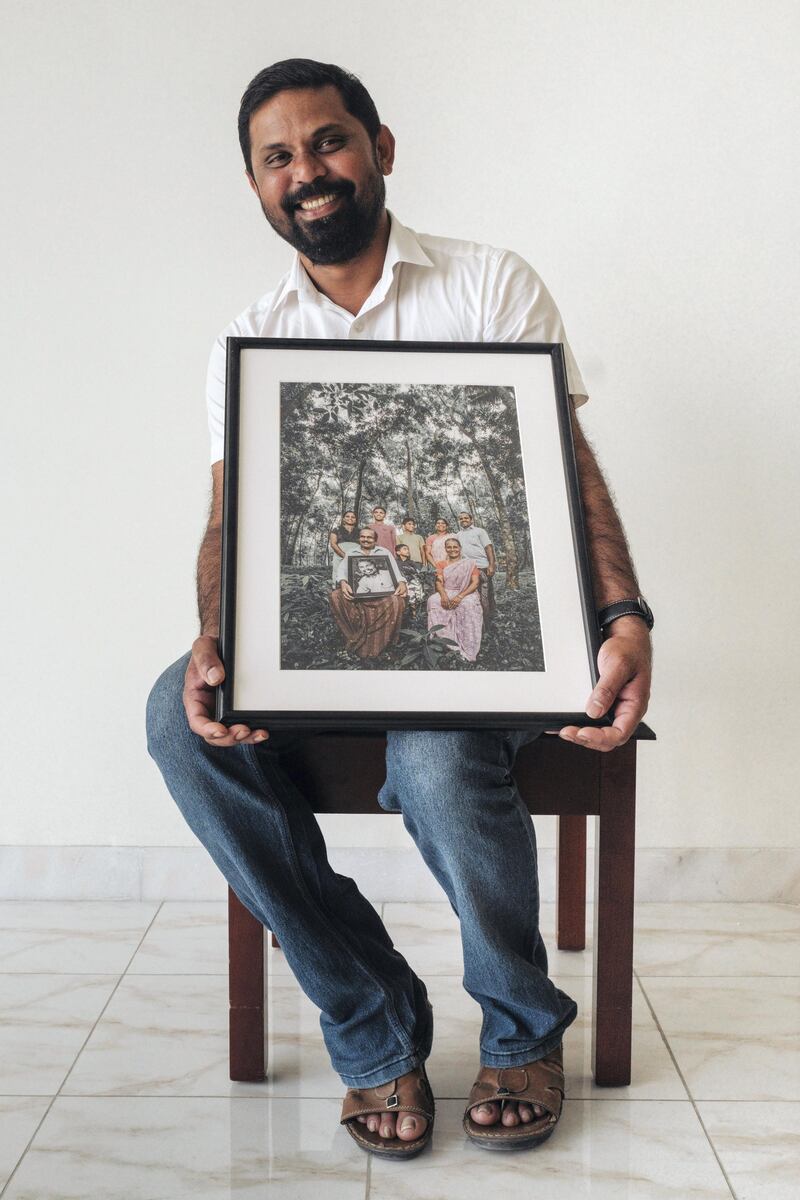 Baiju receives the picture of his family with the portrait of him. As part of a Father’s Day Project, portrait photos of migrants were handed over to relatives in southern India’s Kerala state and images of their family were given to the men who work in Abu Dhabi.