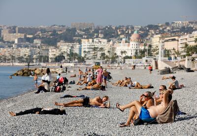 Sunbathers enjoy the unseasonable heat on a French beach on October 27. Reuters 