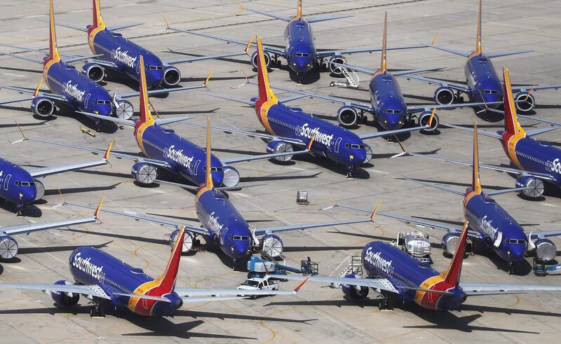 (FILES) In this file photo taken on March 26, 2019 a number of Southwest Airlines Boeing 737 MAX aircraft are parked at Southern California Logistics Airport in Victorville, California.  Boeing on Monday said it expects the 737 MAX airplane, which was grounded after two crashes killed 346 people, to resume flying in January, delaying its return by one month. / AFP / GETTY IMAGES NORTH AMERICA / MARIO TAMA
