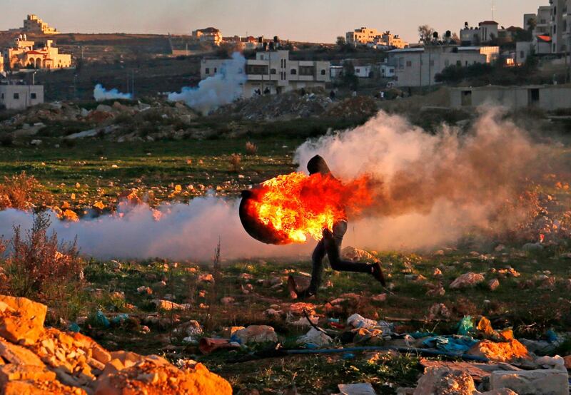 Protesters near the Jewish settlement of Beit El, in the occupied West Bank as Israeli forces carry out fresh raids. AFP