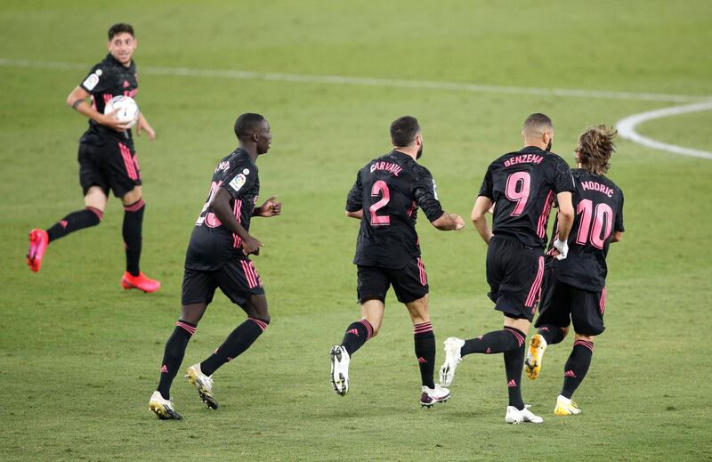 Real's Karim Benzema of Real Madrid celebrates with teammates after Emerson's own goal. Getty