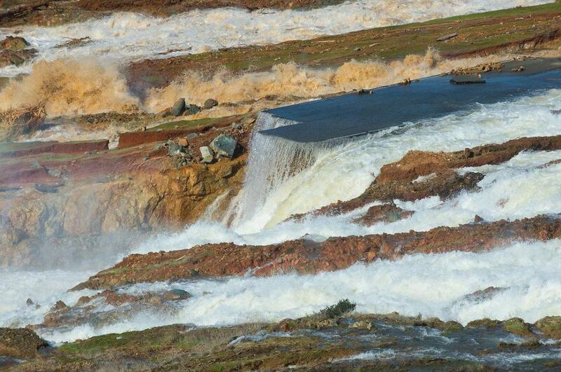 Water from the Oroville dam auxiliary spillway at Lake Oroville eroding the roadway just below the spillway that leads to the spillway boat ramp, in Oroville, California, on February 12, 2017. Thousands of residents in living near Lake Oroville have been told to evacuate. Kelly M Grow/EPA, Handout from the California department of water resources