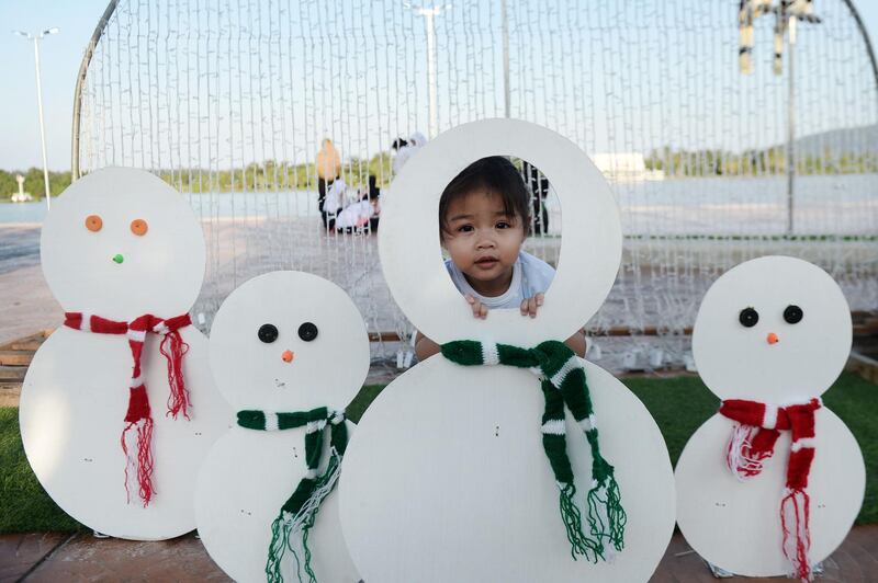 A child playing amid decorations for Christmas in the southern Thai province of Narathiwat.  AFP