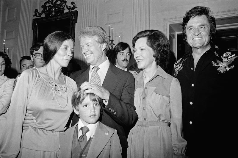 The president and his wife chat with singer Johnny Cash and his family at the White House. Getty Images