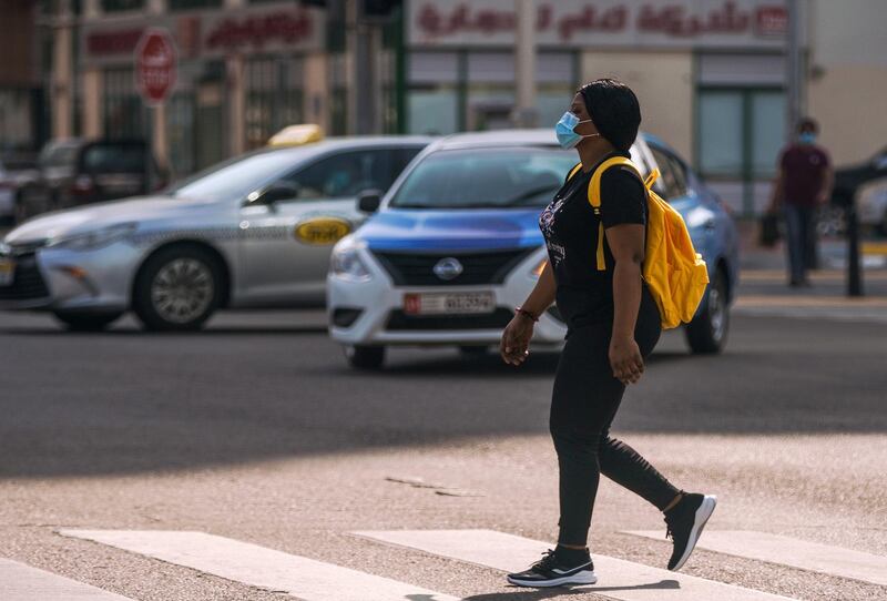 Abu Dhabi, United Arab Emirates, May 27, 2020.  A lady crosses the intersection at the Abu Dhabi World Trade Center Mall area.
Victor Besa  / The National
Section:  Standalone / Stock