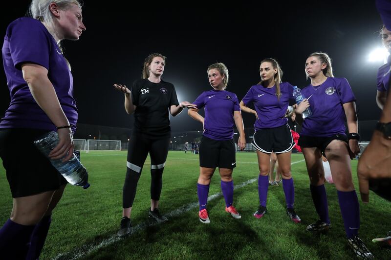 Head coach Lauren McMurchie talks to the team before their match at Royal Grammar School Guildford Dubai.