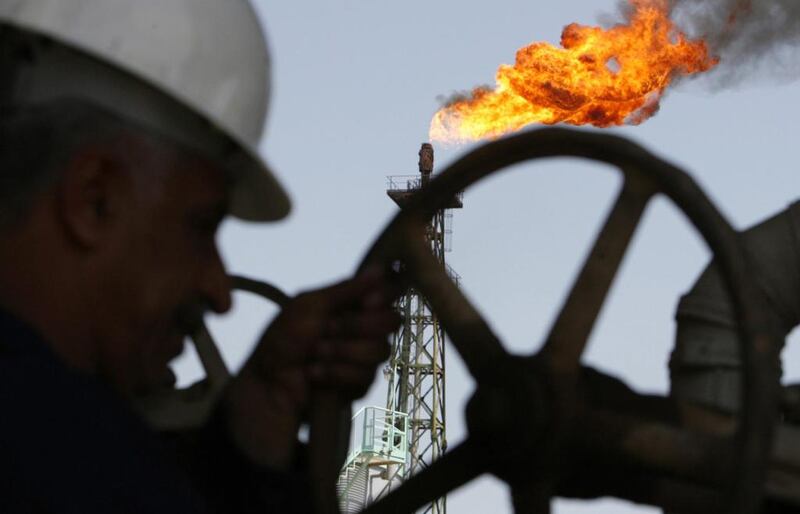 An Iraqi worker opens a pipe at Sheaiba oil refinery in Basra. Atef Hassan / Reuters