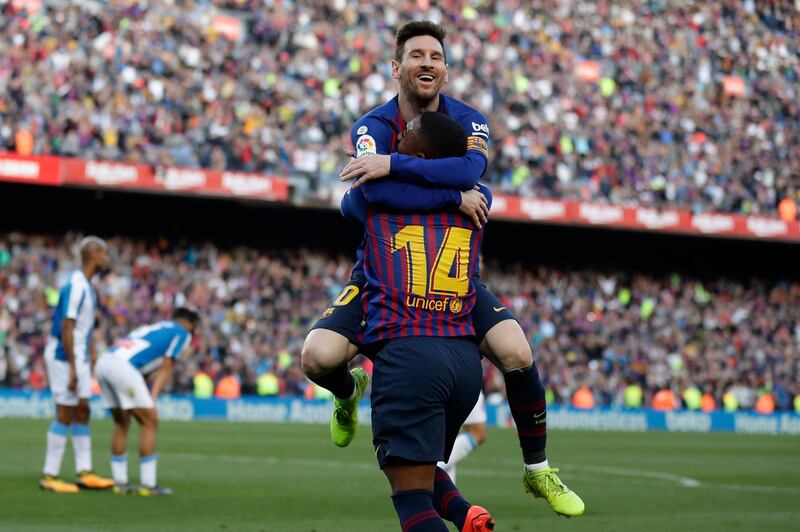 Barcelona's Lionel Messi, top, celebrates with Malcom after scoring his side's second goal during a Spanish La Liga soccer match between FC Barcelona and Espanyol at the Camp Nou stadium in Barcelona, Spain, Saturday March 30, 2019. (AP Photo/Manu Fernandez)
