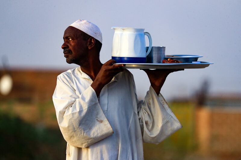 Iftar is served outside a mosque on the Jazeera State highway in the village of Al Nuba, about 50 kilometres south of Sudan's capital Khartoum. AFP