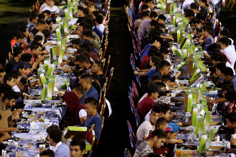 Orphans eat their iftar meal during Jordan's largest charity event, organised by a society from the UAE for 4,000 children and held at Petra Stadium in Amman. Reuters