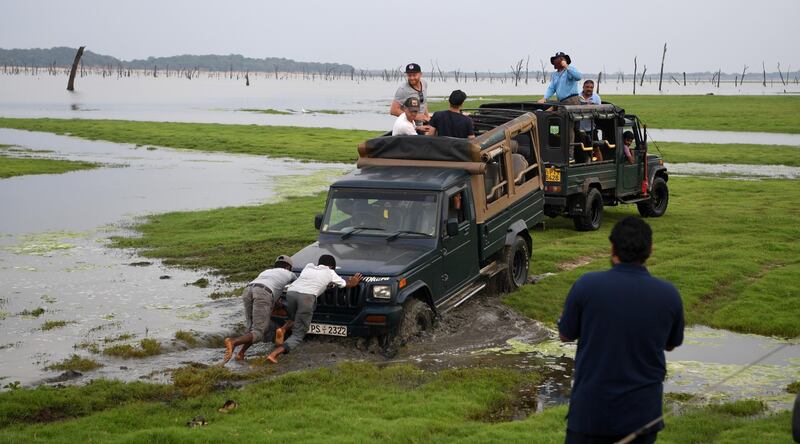 Liam Dawson, Ben Stokes, Olly Stone, Chris Woakes and Jonathan Bairstow of England's truck get stuck in the mud as they take part in an elephant safari at Kaudulla National Park in Dambulla.  Getty Images