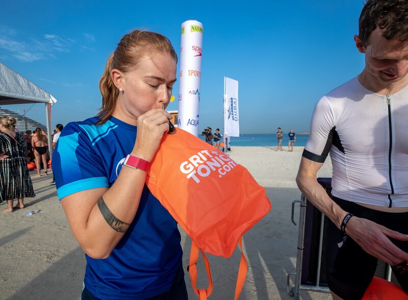 Josie Seidel inflates a flotation device before the race.