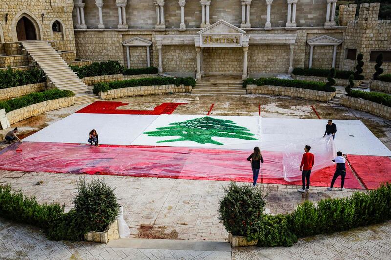 A view of a partially-completed, 300-square-metre Lebanese national flag made from plastic bottles, caps, and empty bullet cartridges is seen at an open-air restaurant and wedding venue in the town of Bnachii in northern Lebanon. AFP