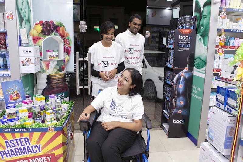 Shobhika Kalra, at Aster Pharmacy where she campaigned to install a ramp, next to her home. With her is Ruchika, her sister, and Reuben Samuel, a volunteer with Wings of Angelz. Reem Mohammed