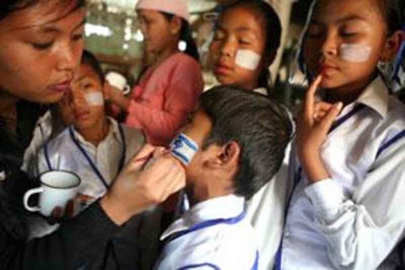 A member of the Bnei Menashe community paints Israeli flags on childrenís faces for the Israeli Independence Day in 2009.
