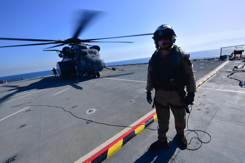 A flight specialist stands in front of an MH-53E Sea Dragon on the deck of the Lewis B. Puller carrier during a joint demining drill between the US, British and French Navy in the Arabian Gulf. The US, French and British navies have launched anti-mine exercises off Bahrain in support of the free movement of trade in Gulf waters, a military spokeswoman said Monday.   AFP