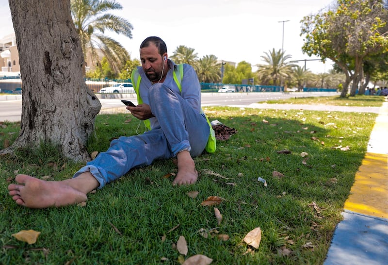 Abu Dhabi, United Arab Emirates, June 15, 2019.  
The UAE's mandatory midday break for people working outdoors during the summer months will come into force on Saturday. --  Pakistani workers take refuge under the shade of a tree along Al Dhafra street.
Victor Besa/The National
Section:  NA
Reporter: