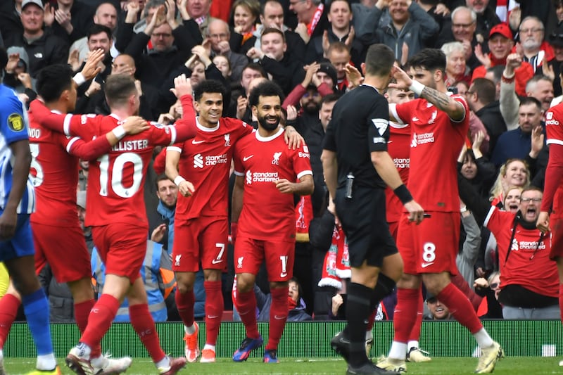 Liverpool's Mohamed Salah, centre, celebrates with teammates after scoring his side's second goal. AP 