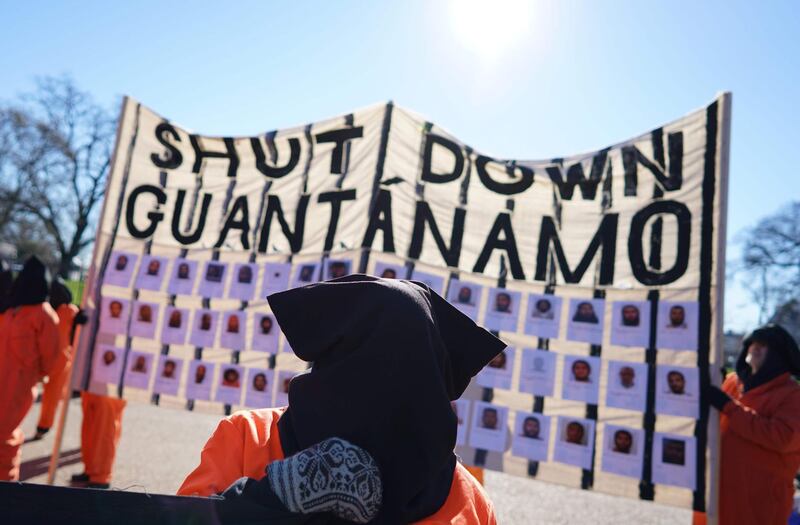 (FILES) In this file photo taken on January 11, 2016 demonstrators take part in a protest calling for the closure of the Guantanamo Bay prison in front of the White House in Washington, DC.  US President Joe Biden wants to close the Guantanamo Bay prison for terror suspects before the end of his term, the White House said February 12,2021, echoing an unfulfilled campaign promise from Barack Obama's administration. Asked at a press conference about a possible closure of the prison in Cuba during Biden's tenure, spokeswoman Jen Psaki said, "That certainly is our goal and our intention."
 / AFP / MANDEL NGAN
