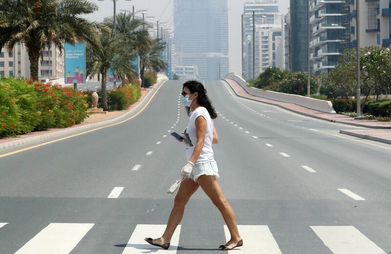 DUBAI, UNITED ARAB EMIRATES , April 17– 2020 :- One of the lady wearing  protective face mask on Palm Jumeirah in Dubai. Dubai is conducting 24 hours sterilisation programme across all areas and communities in the Emirate and told residents to stay at home. UAE government told residents to wear face mask and gloves all the times outside the home whether they are showing symptoms of Covid-19 or not.  (Pawan Singh / The National) For News/Online/Instagram