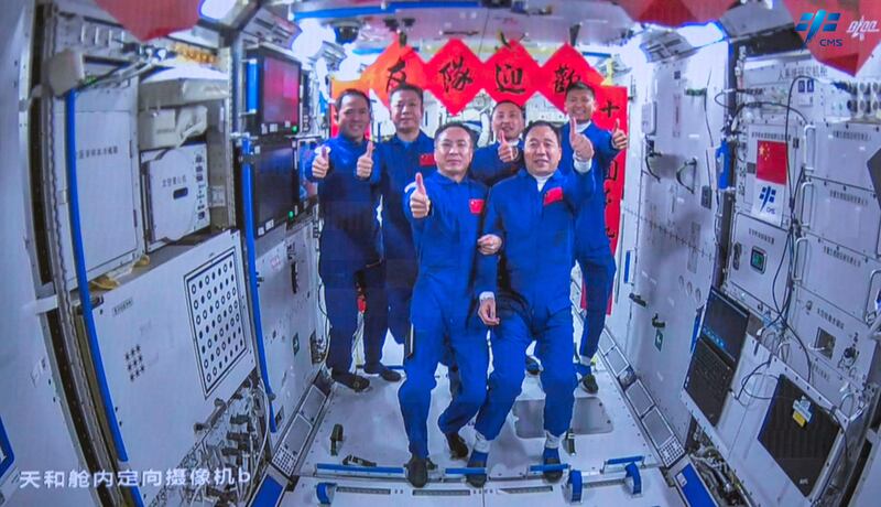 Crew members of the Shenzhou-15 spaceflight mission take photos with Shenzhou-16 crew in the Chinese space station core module Tianhe. AFP