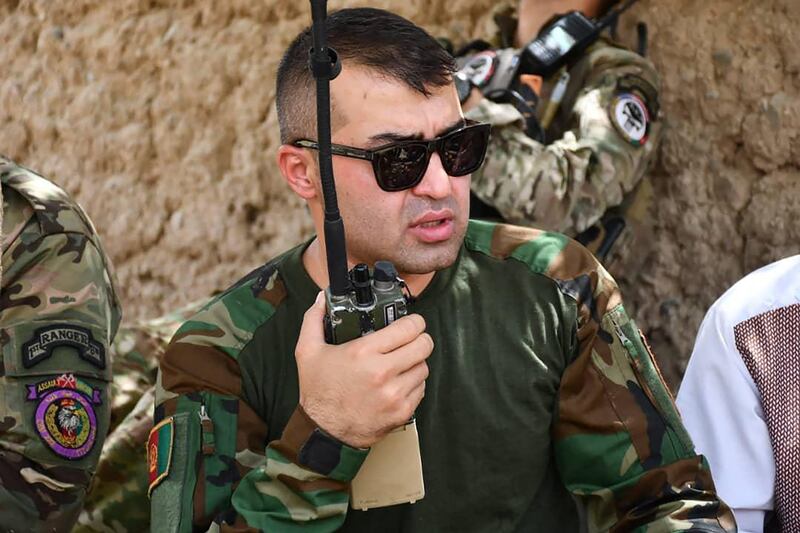 Sami Sadat, commander of the 215 Maiwand Afghan Army Corps, talks on the radio in Helmand province.  AFP Photo  /  Public Relation Office of 215 Maiwand corps