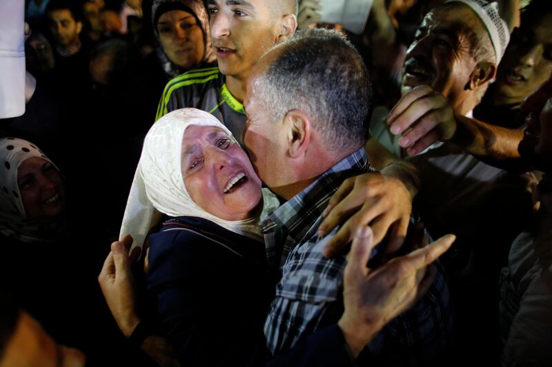 Freed Palestinian prisoner Jamil Nabi Annatsheh (R) is greeted by his mother upon his arrival in the West Bank city of Ramallah August 14, 2013. Israel freed 26 Palestinian prisoners on Wednesday to keep U.S.-sponsored peacemaking on course for a second round of talks, but diplomacy remained dogged by Israeli plans for more Jewish homes on land the Palestinians claim for a future state. REUTERS/Ammar Awad (WEST BANK - Tags: POLITICS) *** Local Caption ***  DTW107_PALESTINIANS_0814_11.JPG