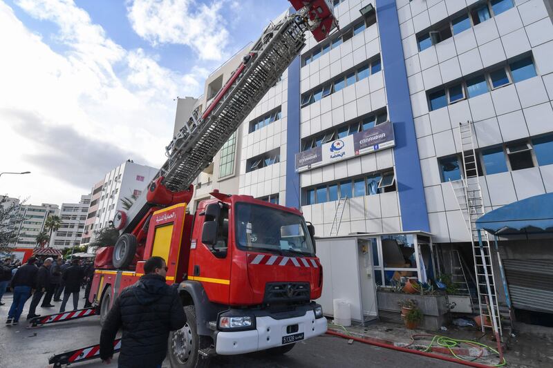 Tunisian firefighters put out a blaze at the Islamist party Ennahda's headquarters in Tunis on December 9. AFP