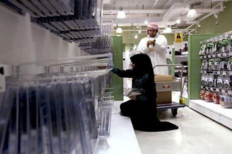 Emirati employees stock shelves at the Sharaf DG electronics store at the Century Mall in Fujairah. Christopher Pike / The National