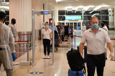 Passengers at Dubai International Airport must undergo health screening. AFP