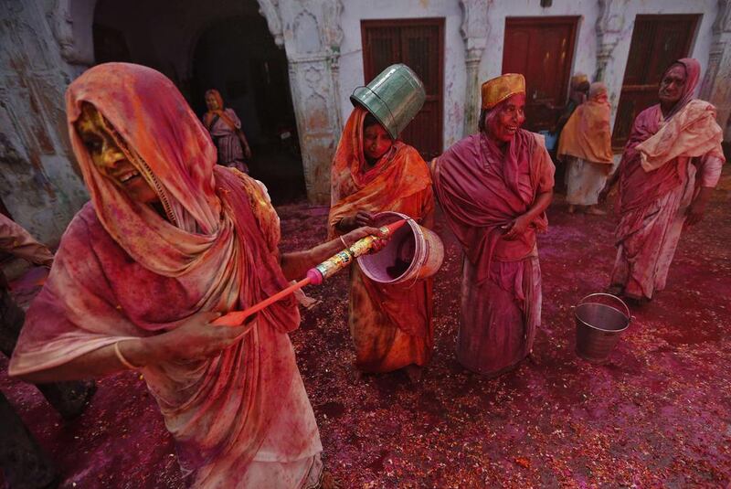 Widows daubed in colours as they take part in Holi celebrations organised by non-governmental organisation Sulabh International at a widows' ashram in Vrindavan in the northern Indian state of Uttar Pradesh. Traditionally in Hindu culture, widows are expected to renounce earthly pleasure so they do not celebrate Holi. Adnan Abidi / Reuters