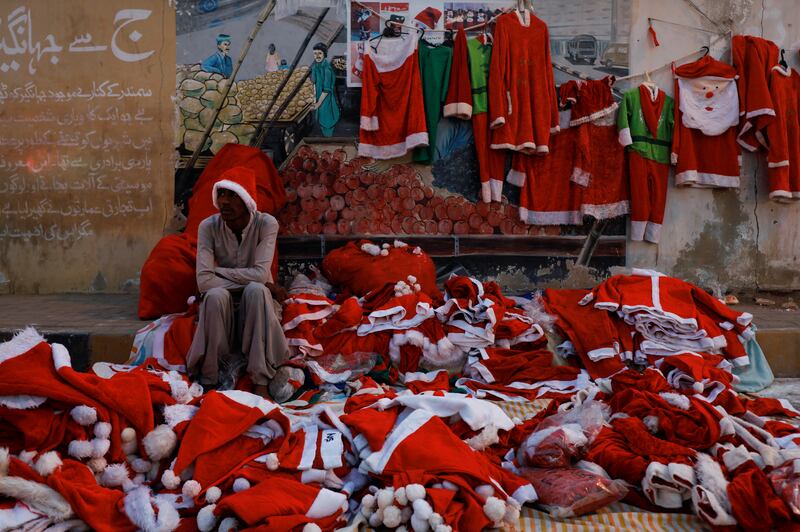 Jason, 17, sells Santa Claus costumes at St Patrick's Cathedral in Karachi, Pakistan. Reuters